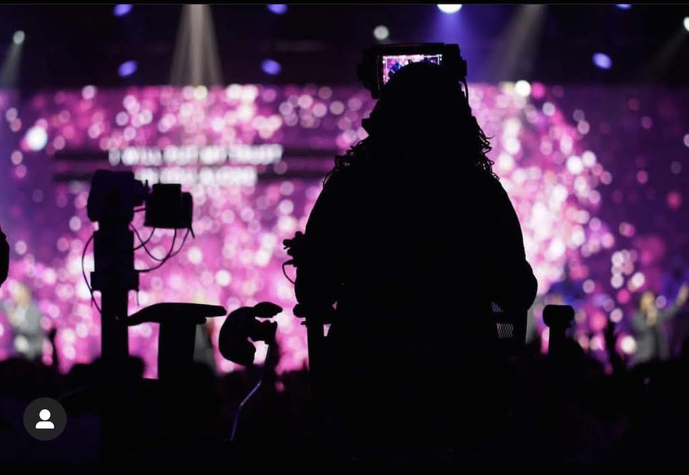 COTH videographer with purple stage light.jpg